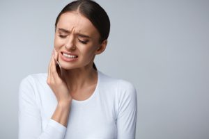 Tooth Pain And Dentistry. Beautiful Young Woman Suffering From Terrible Strong Teeth Pain, Touching Cheek With Hand. Female Feeling Painful Toothache. Dental Care And Health Concept. High Resolution