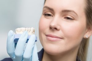 close up of female dental technician working on artificial dention